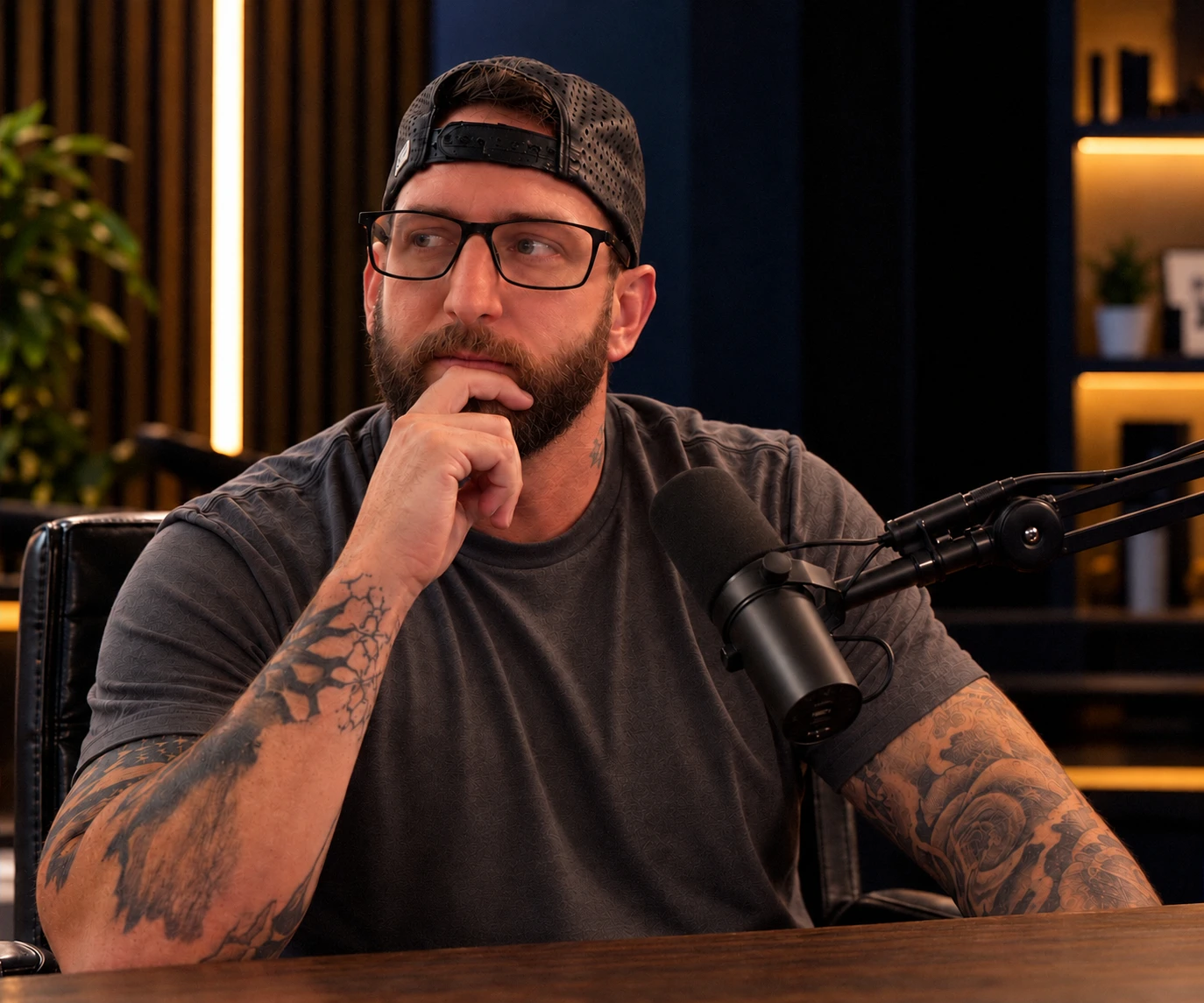 Kevin M. Coles seated at a podcast microphone